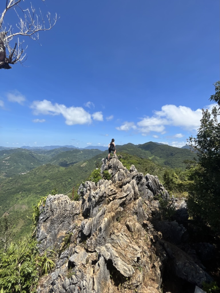 Pam walking along a jagged limestone ridge